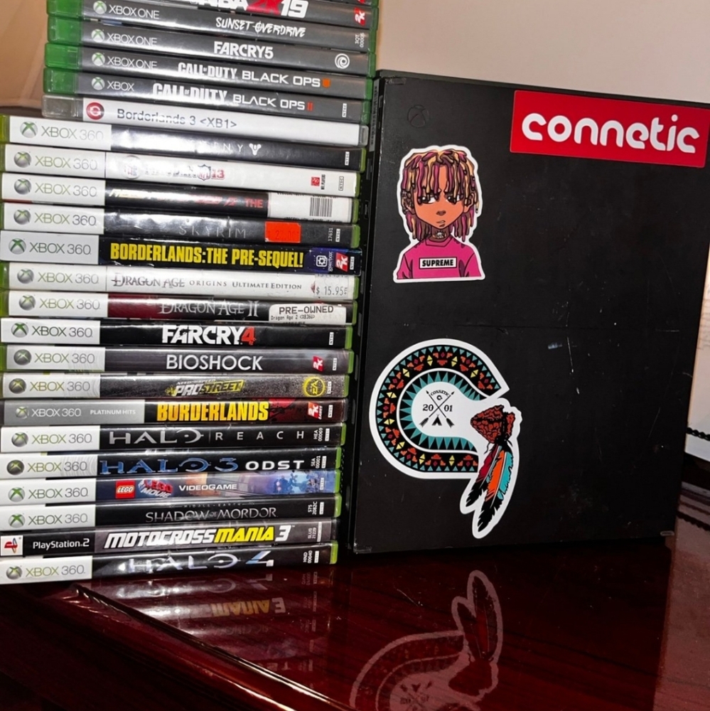 Xbox and 2 game controllers with recharge batteries with selected game